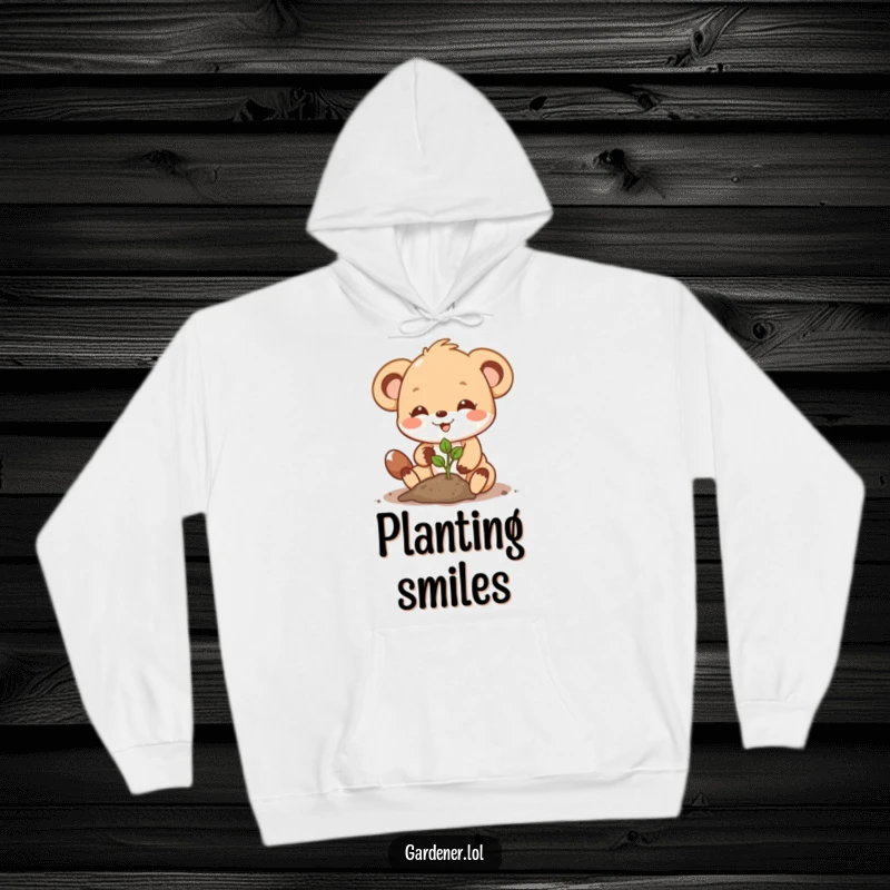 Funny Hoodie: A cute animal character joyfully plants a seedling with a determined smile, exuding natural charm.